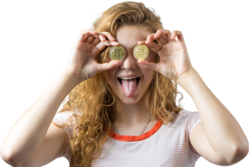 Young red-haired curly girl over white background holding piggy bank and rejoices gesturing. The concept of reliability of cash investments and insurance. Girl puts in the piggy bank physical Bitcoin