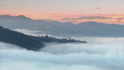 the valley between the hills in the fog	
