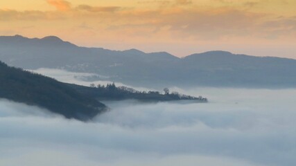 the valley between the hills in the fog	
