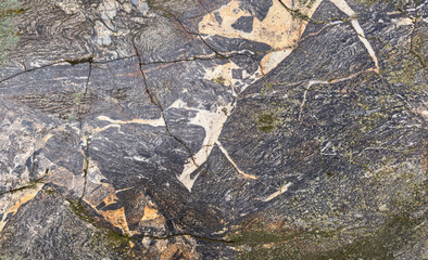 Natural rock formation showcasing complex patterns and fractures.
