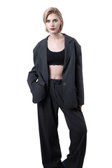 Portrait of a seductive, stylish business lady in the studio. Blonde girl in a suit and top.