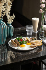 Portion of breakfast with sausages and fried eggs