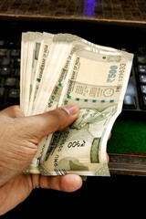 Man Hand holding Rupees 500 bank note savings