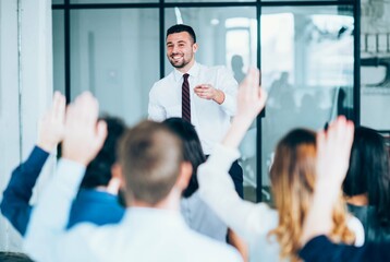 Speaker Engaging with Audience in Meeting, Business Presentation with Raised Hands, Professional Seminar with Interactive Discussion