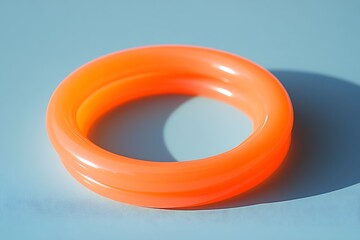 Orange ring on light blue surface