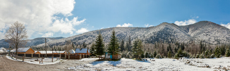   Carpathian village meets spring snowfall: snow-covered roofs