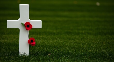 Obraz premium Memorial Day Honor: White Cross Adorned with Poppies Stands Solemnly on Lush Green Grass, Reminding of Sacrifice and Remembrance