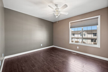 Large room with a wooden floor and a white ceiling
