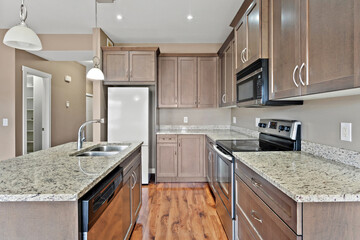 Kitchen with a white refrigerator, microwave, and oven