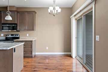 Kitchen with a white wall and a wooden floor