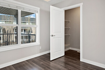 White door is open in a room with a window