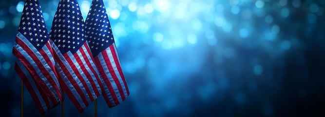 Patriotic USA flags waving against blurry blue bokeh background with stars and stripes