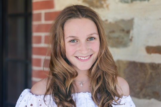 portrait of a pretty teenager with long curled hair