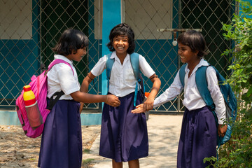 Three schoolgirls playing and smiling