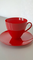 Red teacup and saucer on white background, simple breakfast scene, ideal for menu design