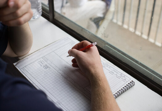 Man scoring at a cricket match