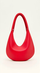 Red crescent handbag on white background; studio shot; fashion accessory; e-commerce product photo