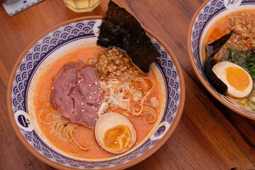 kirin shoyu. ramen noodles with half boiled egg, nori, tam-tam, sliced chicken. spicy ramen noodle soup.