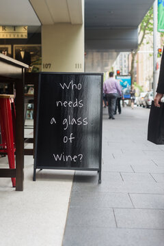 sign reading "who needs a glass of wine?"