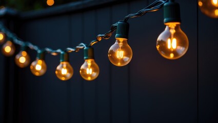 Black background with illuminated string garlands and bulbs for outdoor festive decor