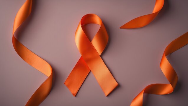 Top view of an orange awareness ribbon on a background with space for text.
