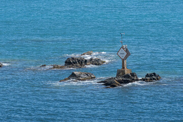 Sign warning of dangerous rocks in seaport entrance
