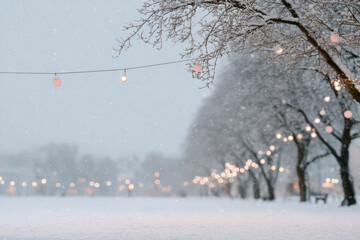 serene winter landscape adorned with glowing garlands softly illuminating snowcovered trees and ground