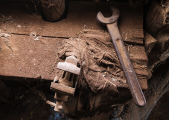 Old tools on a dusty bench looking from above