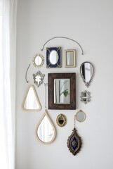Various decorative mirrors arranged on a wall