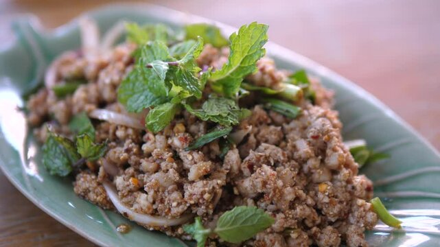 Spicy Thai Minced Pork Salad (Larb Moo) Served with Fresh Mint &ndash; Traditional Thai Cuisine Close-up