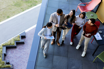 Team brainstorming and collaboration on a terrace during a sunny afternoon in a modern setting