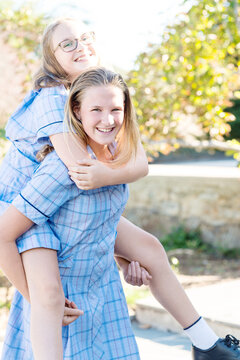 sisters mucking about in school uniform