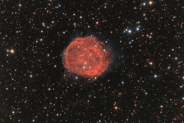 Red nebula in a star-studded cosmos