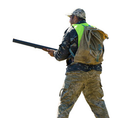 Hunter man in camouflage with a gun during the hunt in search of wild birds or game. Autumn hunting...