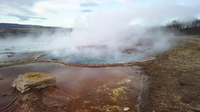 The most famous hot water geyser in Iceland, boiling and waiting to erupt. The Geysir can hurl boiling water up to 60 meters in the air. Slow motion video