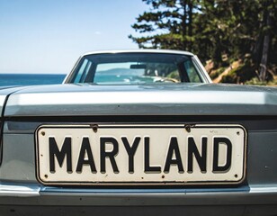 Vintage car with maryland license plate by ocean roadside