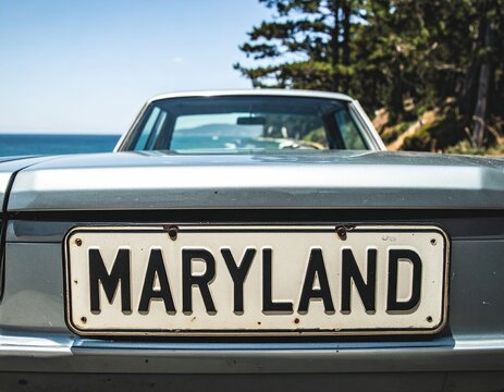 Fototapeta Vintage car with maryland license plate by ocean roadside