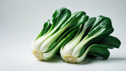 Raw organic bok choy plant on plain white backdrop