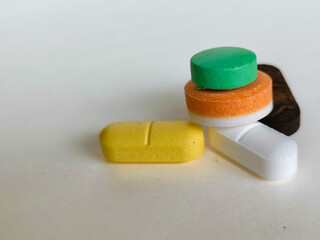 close up colored medicine pills isolated on white background