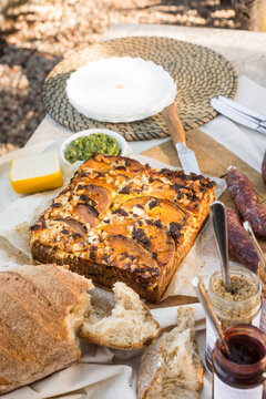 frittata with pumpkin, pine nuts, pesto and green beans in an outdoor setting