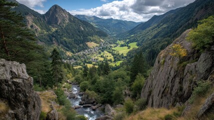 Fototapeta premium Mountain valley with trees and a river under a cloudy blue sky.
