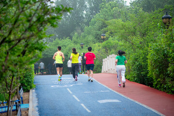 Luannan County, Hebei Province, China - May 2024: People taking morning walks and doing exercises in urban parks to exercise their bodies