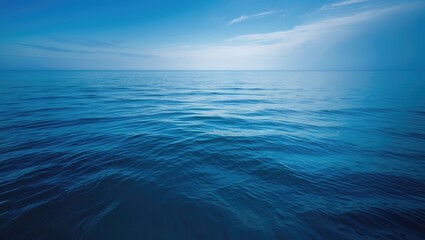 Obraz premium Beautiful natural beach scene with clear water, light clouds, and the horizon under a sunny blue sky, perfect for tourism and relaxation.