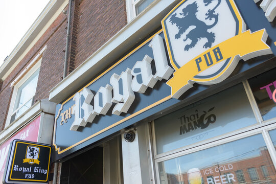 skyward view of sign outside The Royal King Pub, located at 641 Dupont St, Toronto
