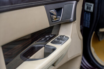 Close-up of control buttons on the door of a modern car.