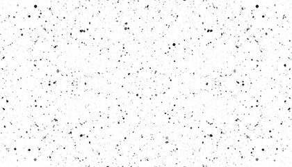 Obraz premium A textured white background with varying sizes of black and gray speckles, creating a modern, abstract design