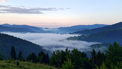 Obraz premium Serene sunrise over misty mountain valley. Breathtaking panoramic view of rolling hills, forests, and low-lying clouds. Peaceful nature scene.