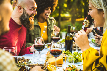 Happy friends having bbq dinner party in garden restaurant