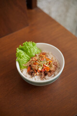 Indonesian Spicy Beef Matah, Delicious Bowl of Rice Topped With Savory Meat and Fresh Greens in a Cozy Setting
