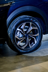 Car wheel with brake calipers and stylish design.